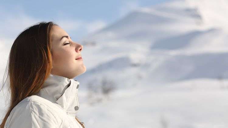 Woman Breathing Fresh Air on Mountain Top
